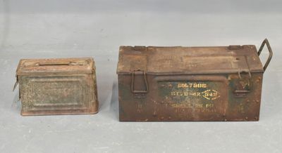 an old metal box and a small metal box sitting on a table