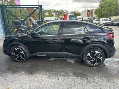 a black suv parked in a parking lot next to other cars