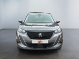 the front view of a silver car in a white room