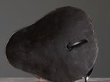 a black object on a white surface with a black handle