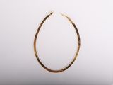 a gold hoop earrings with a gold chain on a white background