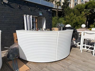a large white tub sitting on top of a wooden deck