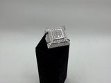 a close up of a diamond ring on a black stand