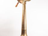 an image of a brass clock on a wooden stand on a white background