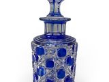 a close up of a blue glass bottle on a white background
