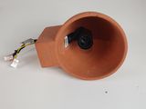 a clay speaker with a wire in it on a white surface
