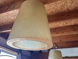 two lamps that are hanging from the ceiling in the room