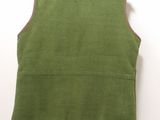 a close up of a green vest on a hanger