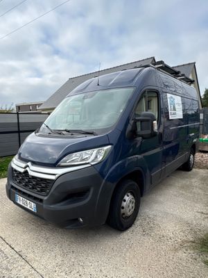 the van is parked on the side of the road in front of a house