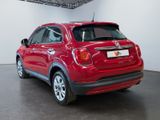 the rear end of a red fiat suv parked in a garage