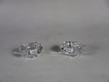 pair of diamond stud earrings sitting on top of a white surface