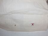 a white bag with a red cross patch on it