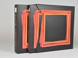 an orange and black book with a picture of a picture in the middle