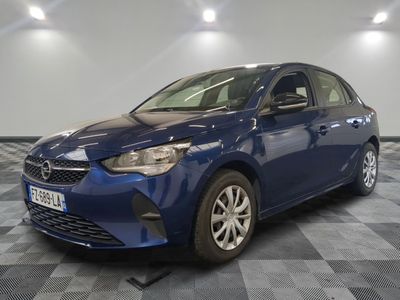 a blue toyota corollant parked in a room with a checkered floor