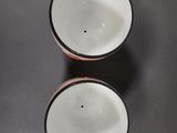 two cups that are sitting on a table