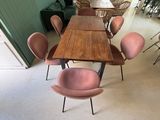 de nombreuses chaises et tables dans une pièce aux murs verts