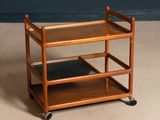 a small wooden cart with two shelves on it