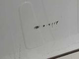 a white refrigerator with a black knob on it