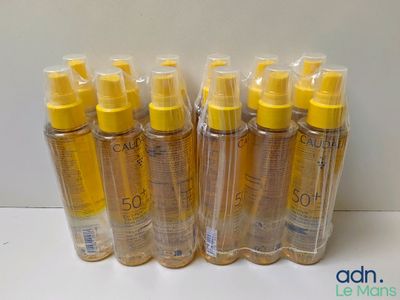four bottles of sun lotion sitting on top of a table