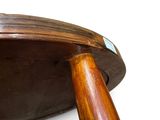 a wooden bowl with a wooden handle on a white surface
