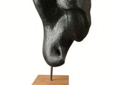 sculpture of a head on a wooden base on a white background