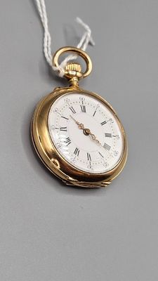 a gold pocket watch with roman numerals on it
