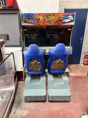two arcade machines sitting next to each other in a room