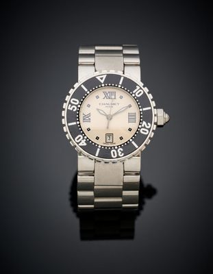 a close up of a watch on a black surface with a black background