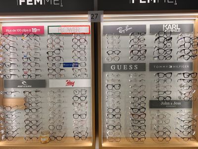 many pairs of glasses on display in a store window