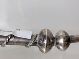 a close up of a metal object on a table with a tag on it