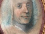 portrait of a man in a gold frame with a red border