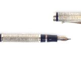 two pens sitting next to each other on a white surface