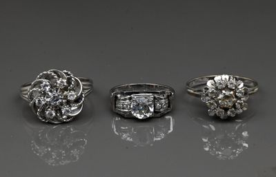 three different types of diamond rings on a reflective surface
