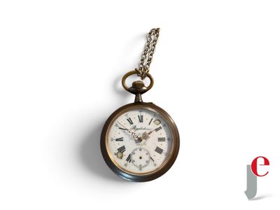 a pocket watch hanging on a chain on a white surface