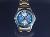a close up of a watch on a blue surface