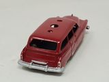 a red toy car that is sitting on a table
