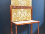 a small wooden table with a chair on top of it