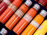 many bottles of colored paint in a display case