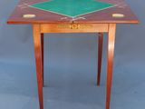 a small wooden table with a green top and a green top