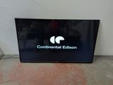 a flat screen television sitting on the floor in front of a wall