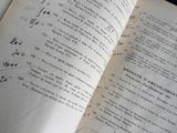 an open book with writing on it sitting on a table
