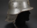 a silver helmet on a black mannequin head