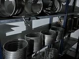 a shelf full of metal pots and pans on it
