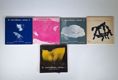 several books are lined up on a white surface