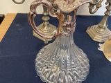 a silver candelab with five candles on a blue table