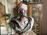 a bust of a woman sitting on a table in a room