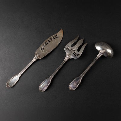 three forks and spoons sitting next to each other on a black surface