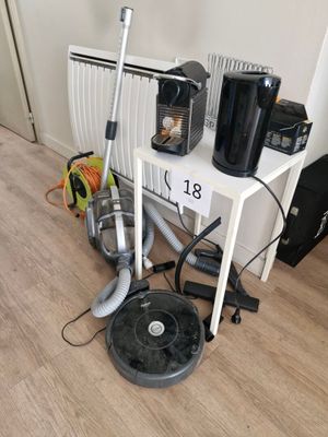 a picture of a room with a vacuum, coffee maker, and other household items