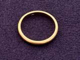 a gold ring on a purple surface