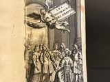 an open book with a drawing of a man holding a sword